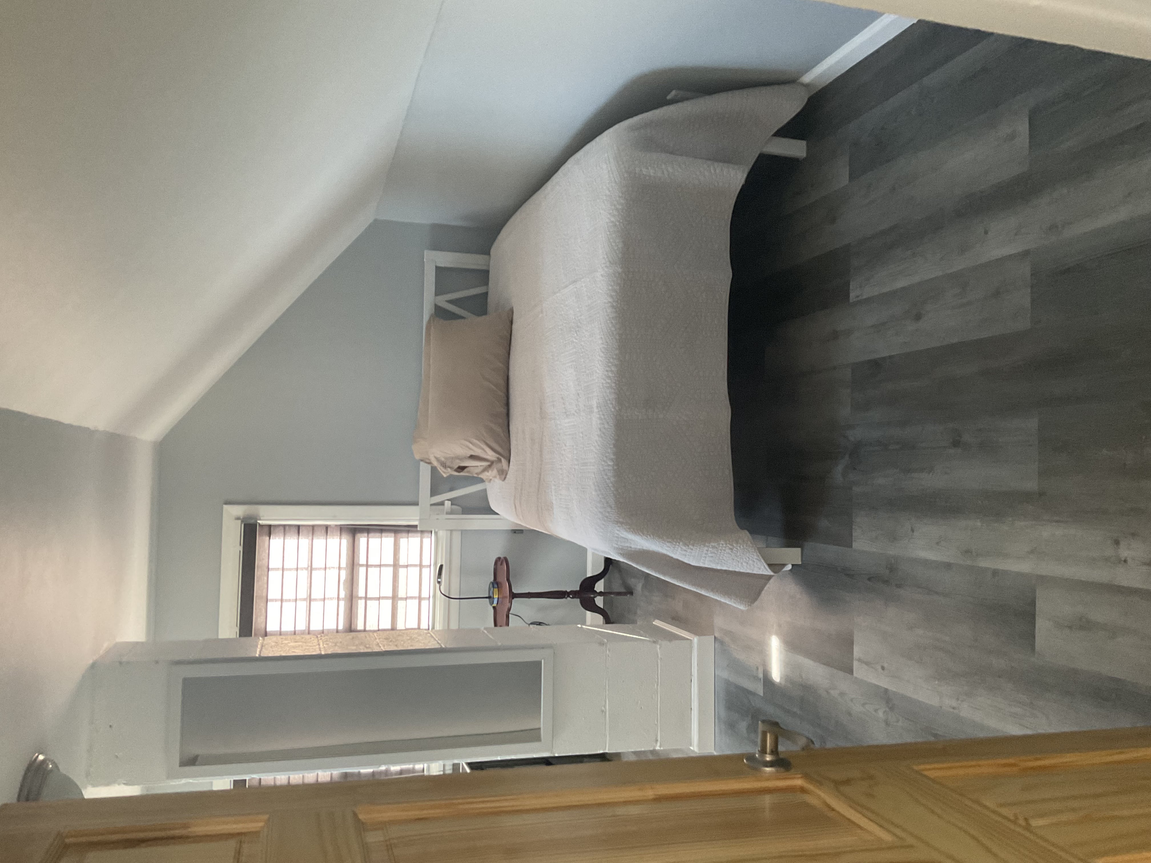Staged residential bedroom turnover with vacuumed carpet and made bed by Ecua Housecleaning