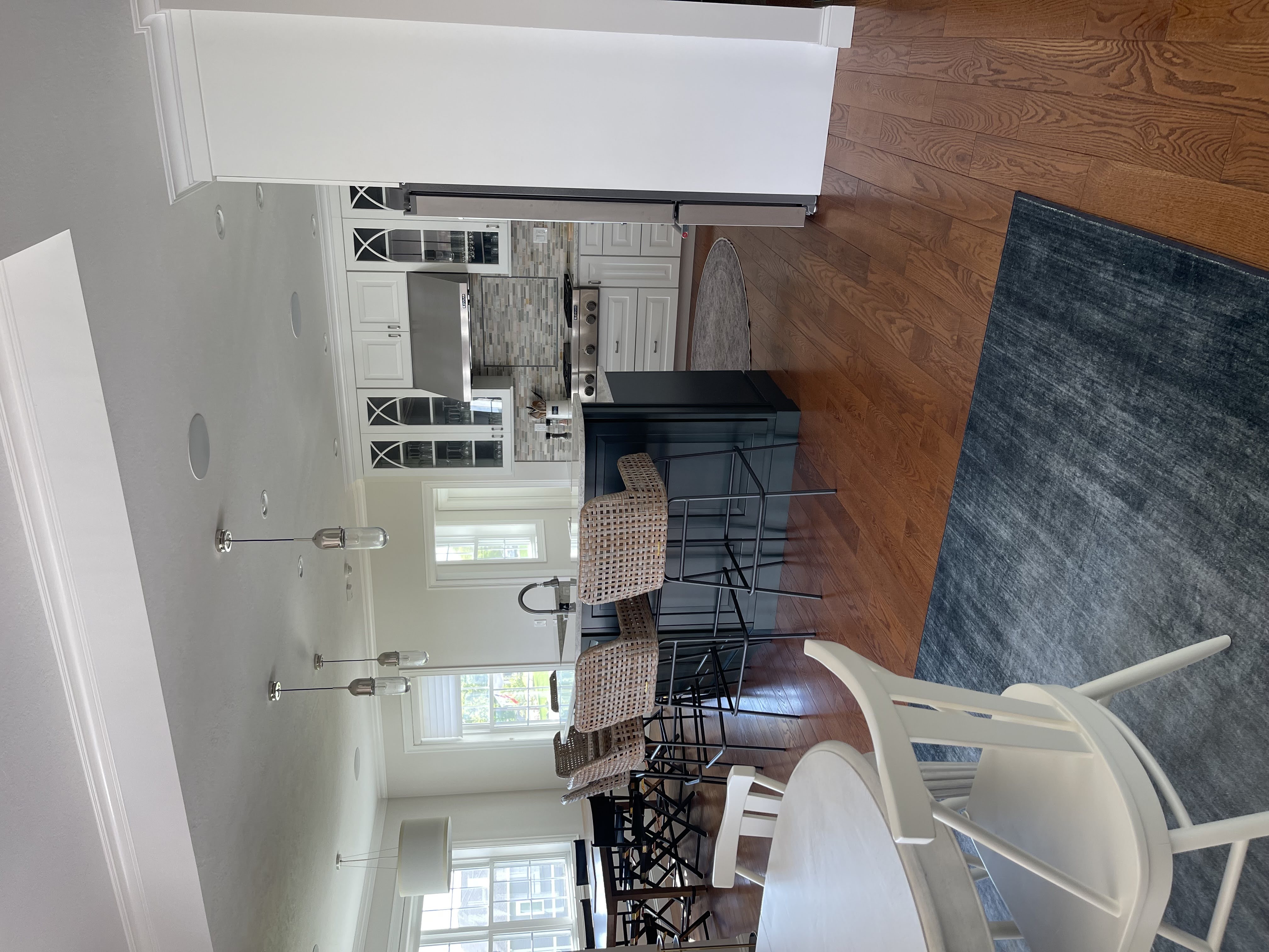 Spotless luxury kitchen with island and stainless steel appliances by Ecua Housecleaning